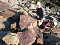 Randy Miller of the Saint John Museum, New Brunswick with two slabs covered in early Pennsylvanian fossil tracks at Tynemouth Creek